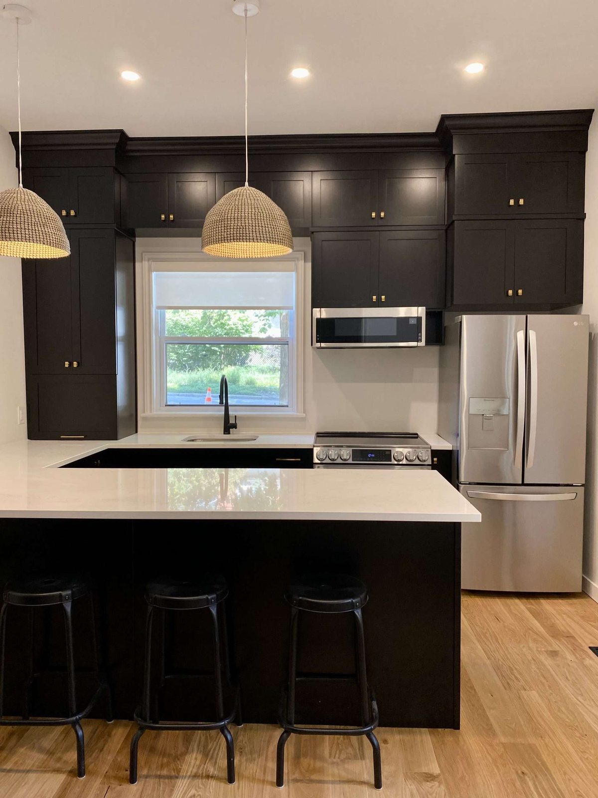 Dark modern kitchen with a large island and bar stools